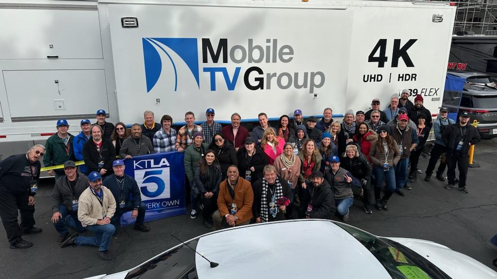 KTLA Rose Parade production team poses for a group photograph in front of a Mobile TV Group 4K broadcast truck after the 2023 Rose Parade.