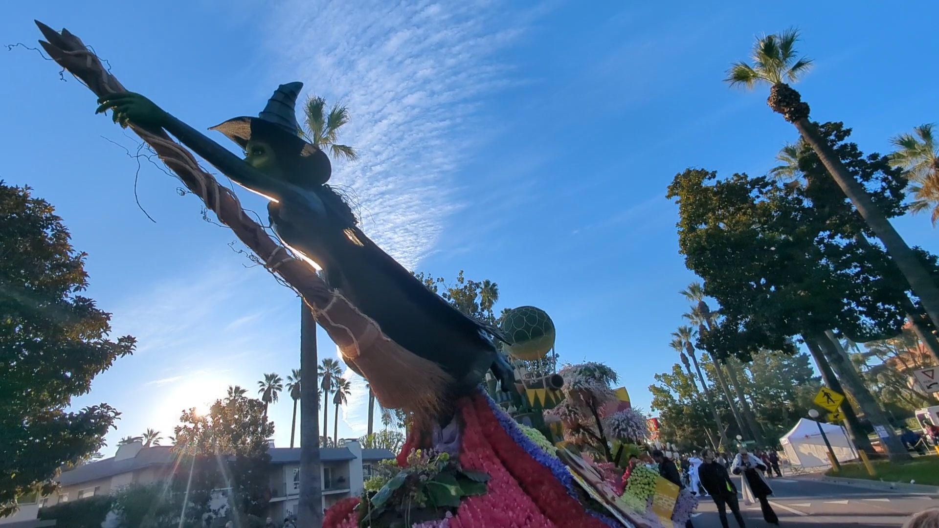 Elaborate Wicked-themed floral float featuring a large witch figure during the 2025 Rose Parade in Pasadena.